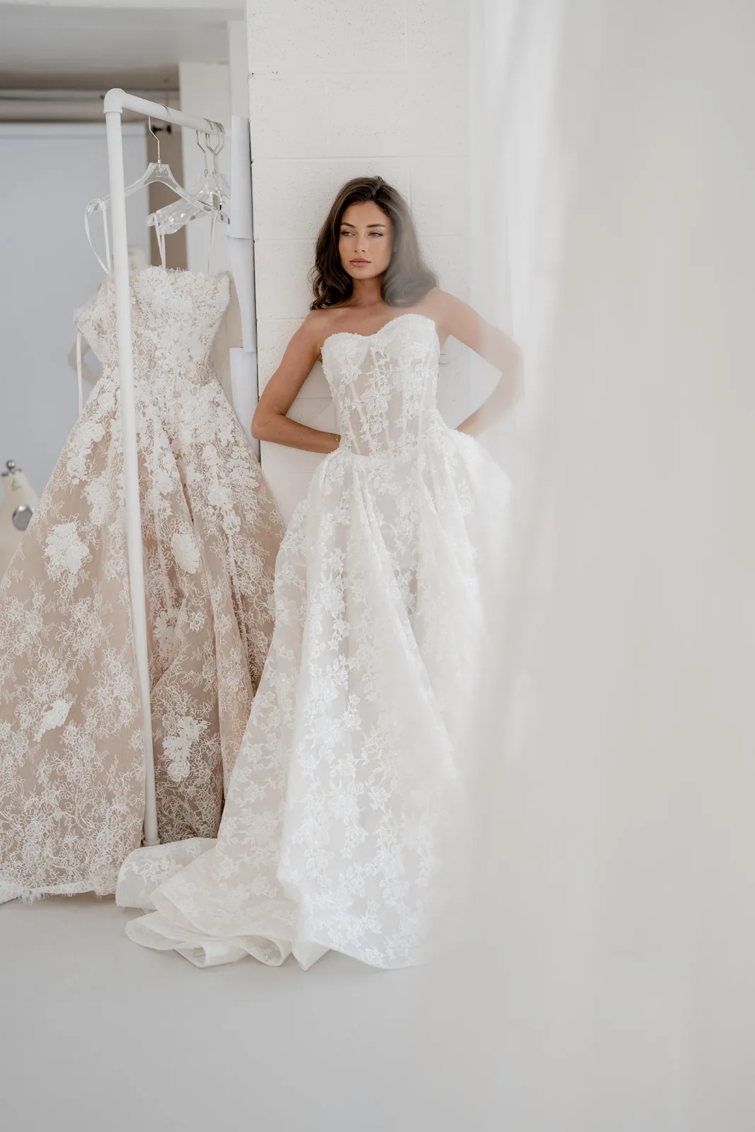 Elara champagne lace gown with an elongated corset and pleated skirt